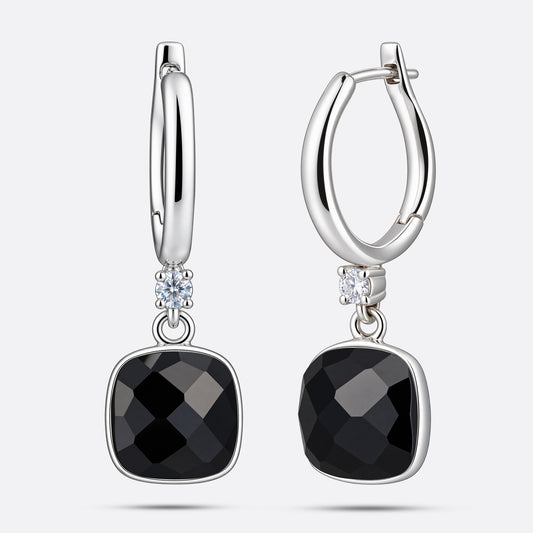 Front and angled views of the silver drop hoop earrings, showing the faceted garnet drops and the hinged fastening.