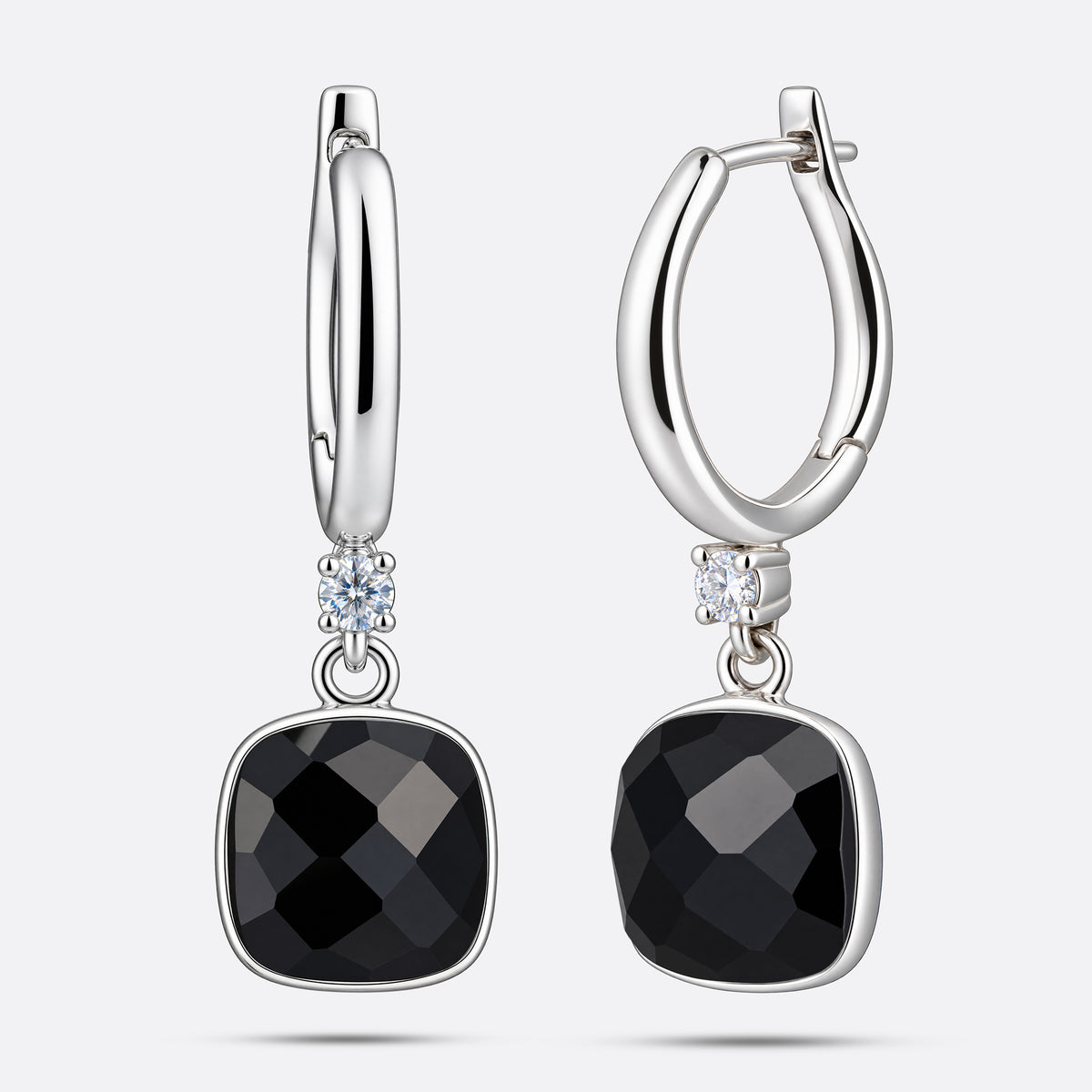 Front and angled views of the silver drop hoop earrings, showing the faceted garnet drops and the hinged fastening.