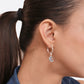 Side profile of a model wearing a sterling silver hoop with a faceted aqua chalcedony drop hanging below the earlobe.