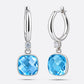 Front and side views of the silver drop hoop earrings, showing the faceted aqua chalcedony and the thickness of its setting.