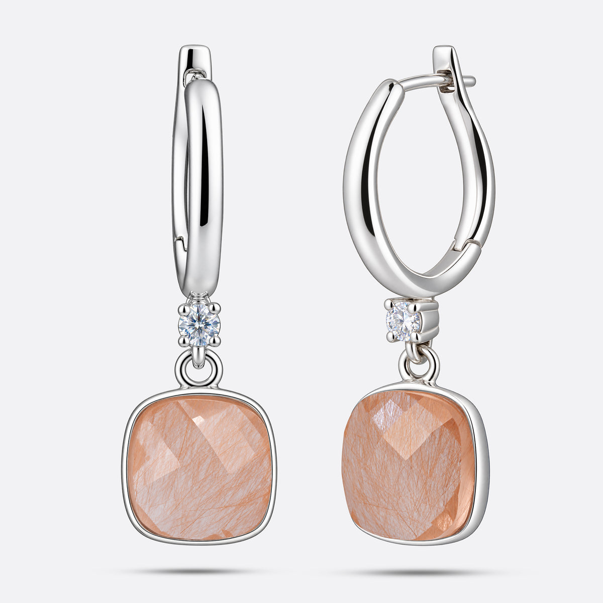 Front and angled views of RILAVE sterling silver drop hoop earrings with cushion-shaped golden rutilated quartz stones.