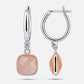 Front and side views of golden rutilated quartz drop hoop earrings, showing the silver settings and hinged clasps.