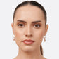 Model wearing RILAVE golden rutilated quartz drop hoop earrings in sterling silver, viewed from the front.
