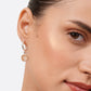Close-up of a sterling silver drop hoop earring worn on the ear, with a faceted golden rutilated quartz drop.