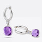 One violet amethyst earring standing upright alongside a second lying flat, demonstrating the articulated drop hinge mechanism.