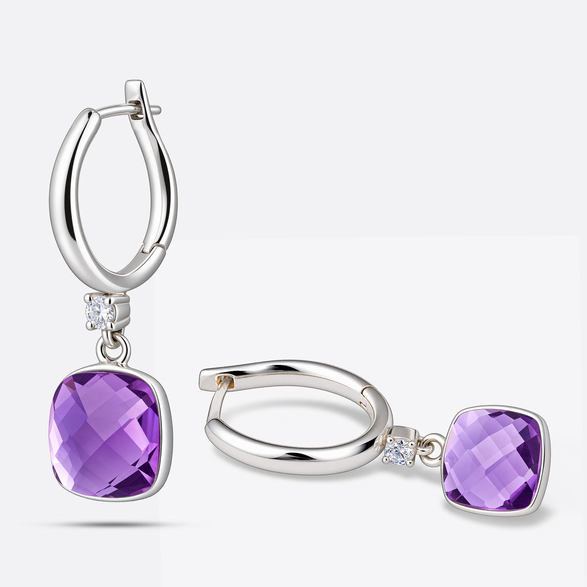 One violet amethyst earring standing upright alongside a second lying flat, demonstrating the articulated drop hinge mechanism.