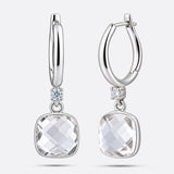 Sterling silver drop hoop earrings featuring a brilliant White Topaz, shown from straight and slightly angled front perspectives.