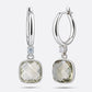Pair of RILAVE Green Amethyst drop hoop earrings shown from the front and at an angle, with faceted pale green gemstones.