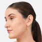 Side-profile portrait of a model wearing a RILAVE Lemon Quartz drop hoop earring with a pale yellow cushion-cut gemstone.