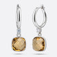 Olive Quartz drop hoop earrings showing a front-facing cushion-cut gemstone and an angled view of the open silver hoop.