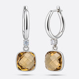 Olive Quartz drop hoop earrings showing a front-facing cushion-cut gemstone and an angled view of the open silver hoop.