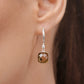 Detailed view of an Olive Quartz drop hoop earring worn on the ear, highlighting the faceted stone and small clear accent.