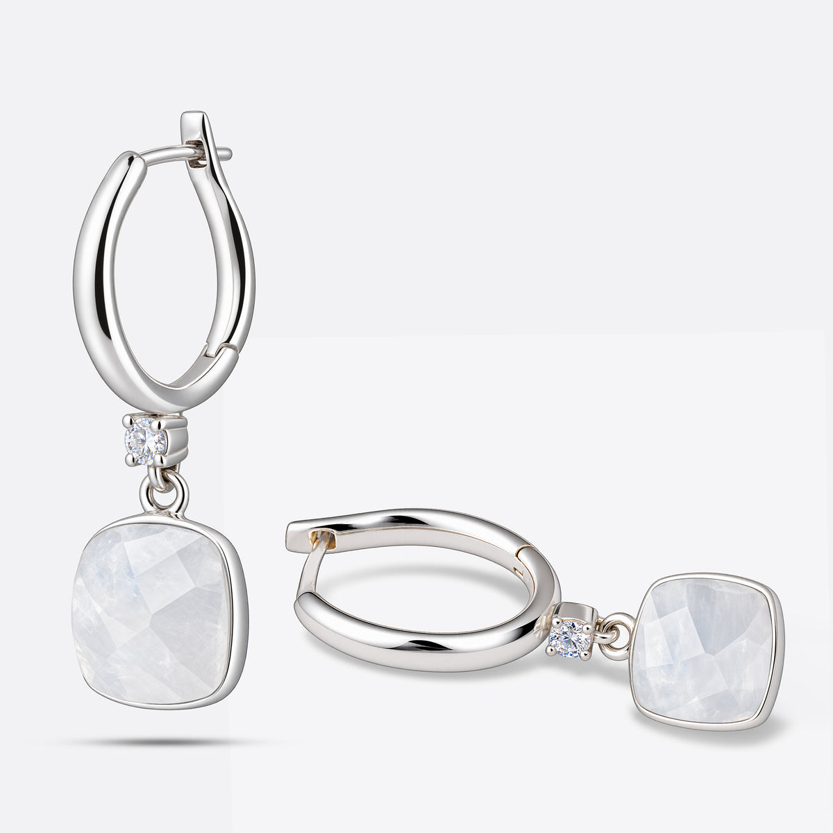 Pair of Rainbow Moonstone drop hoop earrings, one upright and one lying flat, showing their silver hoops and faceted gemstone drops.
