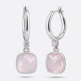RILAVE Lumi Rose Quartz drop hoop earrings shown from the front and at an angle, with faceted pink stones and clear accents.