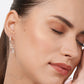 Close-up of a model wearing a Rose Quartz drop hoop earring, showing its faceted pale pink gemstone and polished silver hoop.
